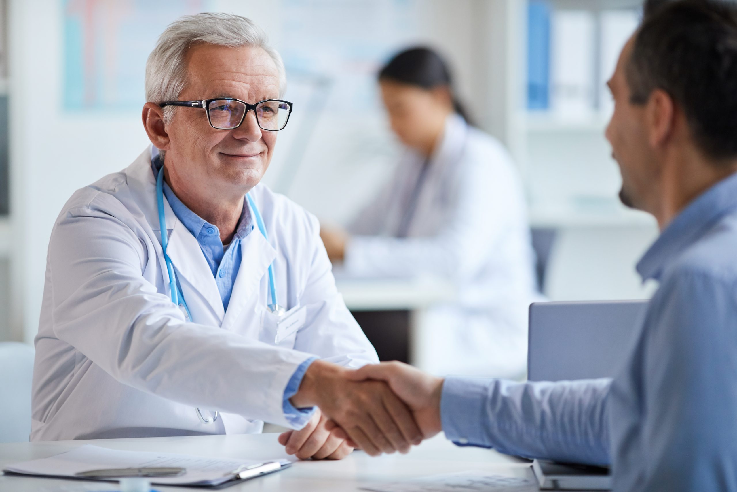 Doctor and patient shaking hands