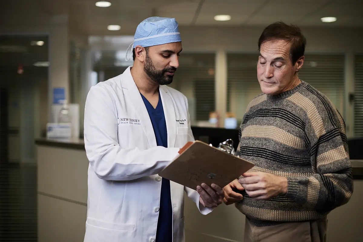 Dr. Mohammed Faraz Khan, spine specialist, consulting with a patient