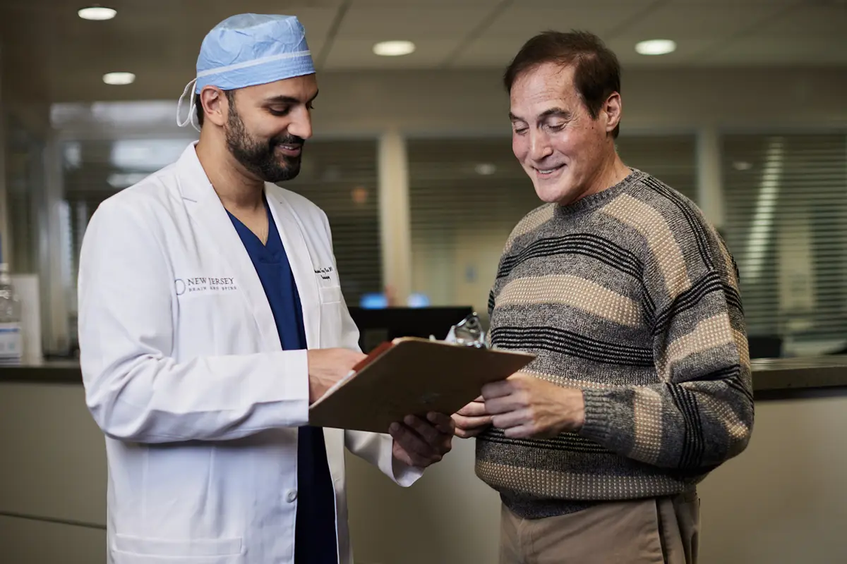 Dr. Mohammed Faraz Khan, spine specialist, consulting with a patient